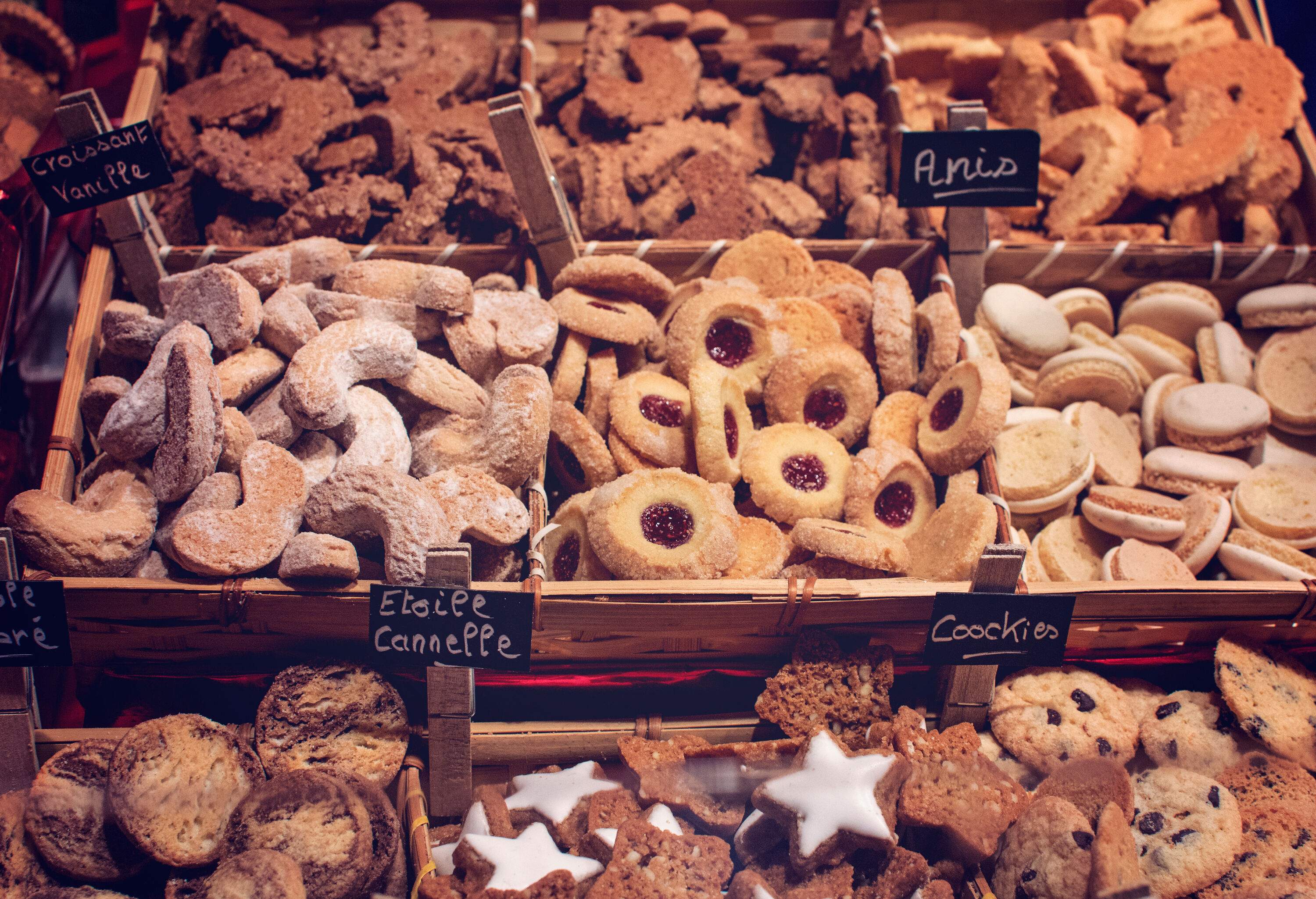 Different cookies with name labels on display are being sold in the market.