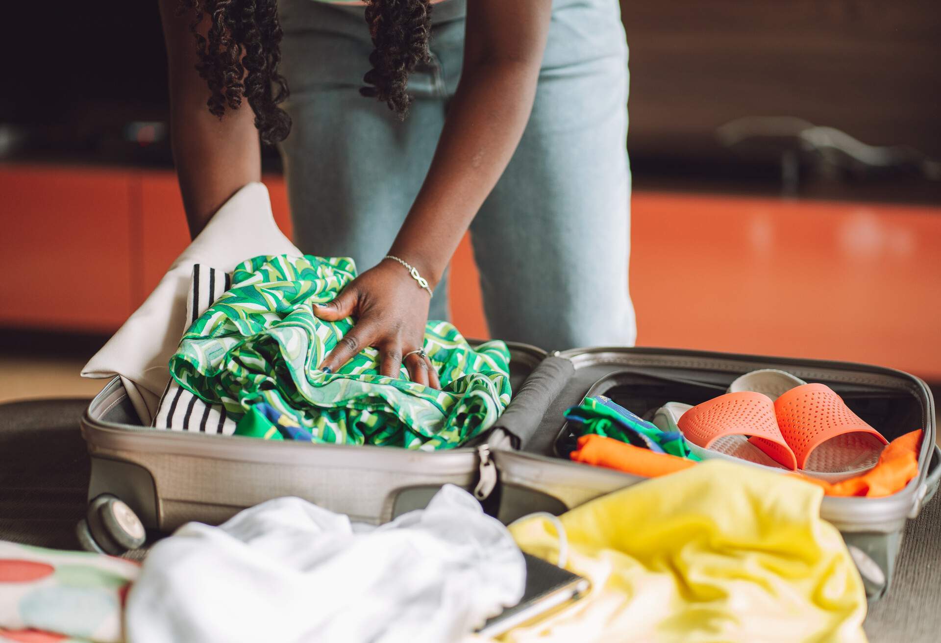 A woman is packing her suitcase